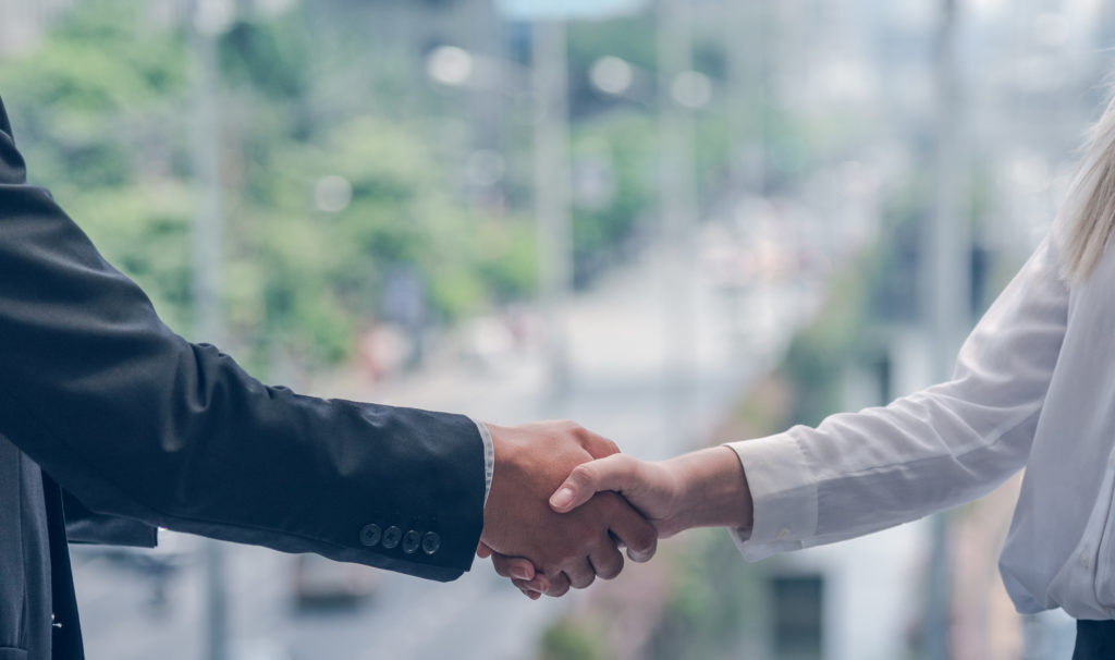 Businessman and businesswoman shake hand for agreement concept success