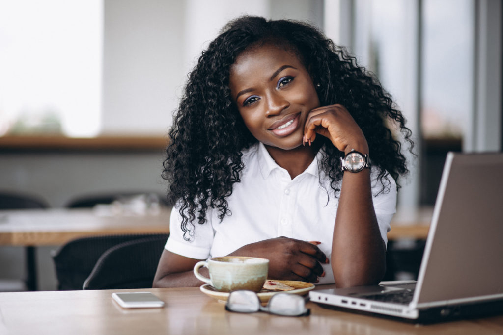 African american business woman with computer and coffee
