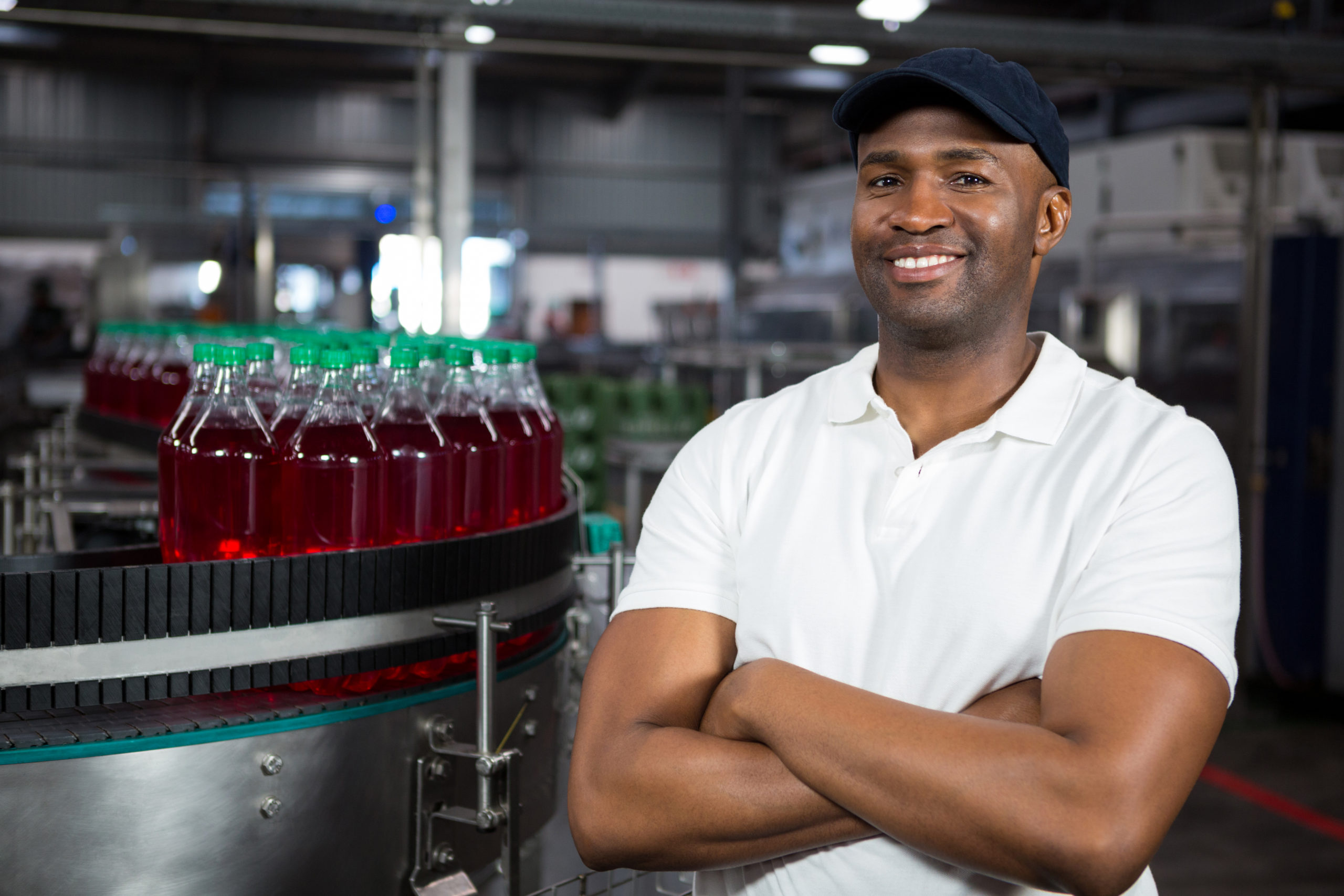 Portrait confident male worker standing in cold drink factory